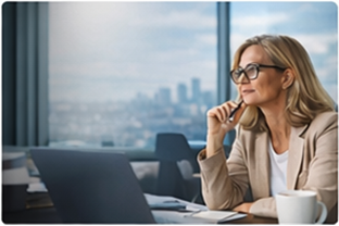 Executive woman sitting at her desk thinking