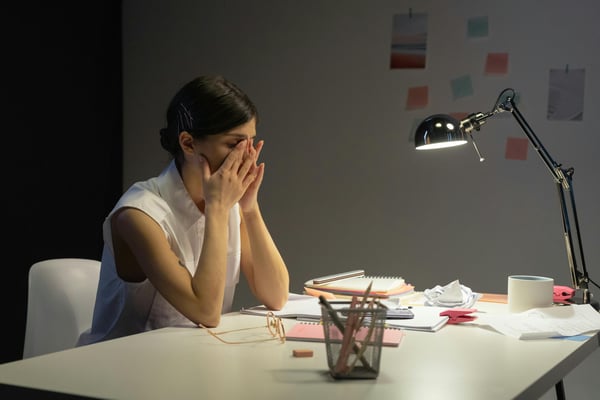 Stressed female leader at her desk
